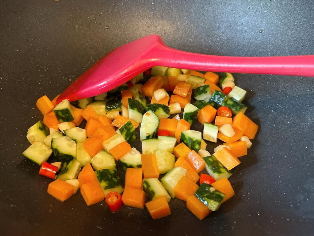 Add the Cucumber: Toss in the diced cucumber. Stir-fry briskly for only 30 seconds.