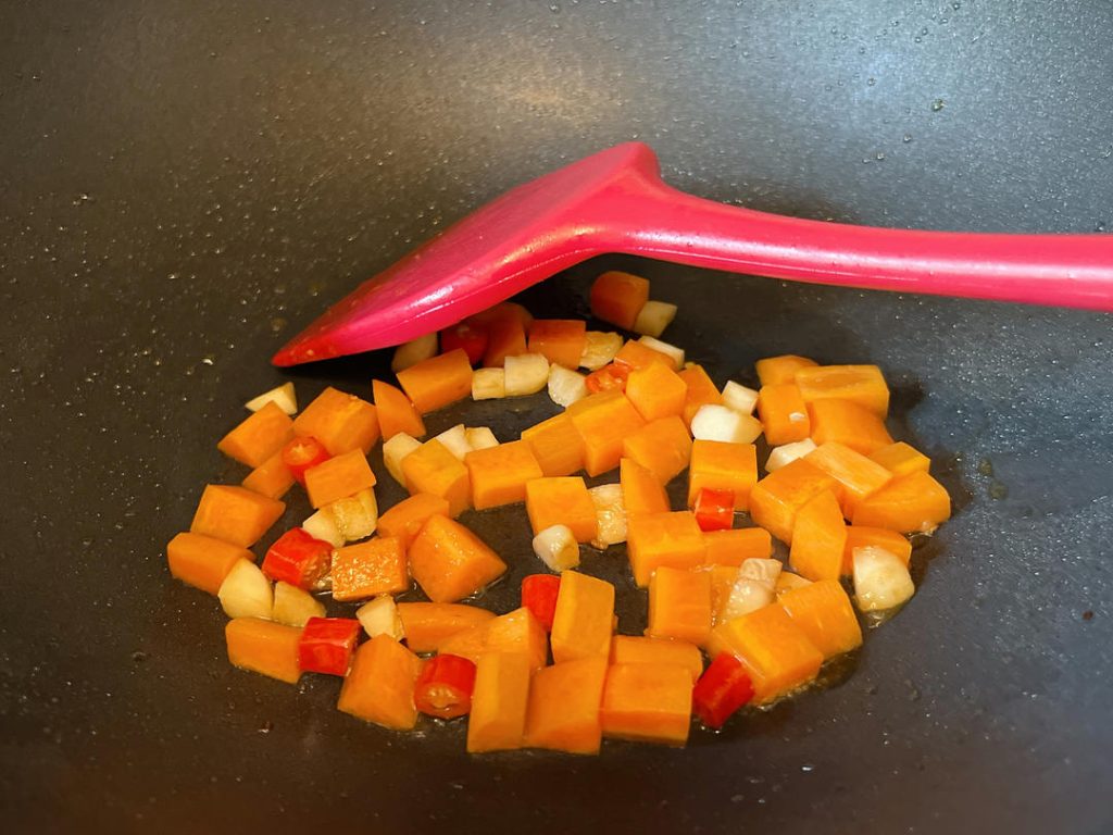 Cook the Carrots: Add the diced carrots. Because they are dense, stir-fry them for about 1-2 minutes until they just begin to soften.