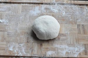 Make the Dough Place the flour in a large bowl. Slowly pour in the hot water while stirring with chopsticks. The flour will look like shaggy flakes. When it’s cool enough to touch, knead it by hand for about 5-8 minutes until you have a smooth, soft dough.