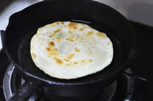 Pan-Fry Heat a non-stick pan over low-medium heat. Brush a tiny amount of oil on the pan (or use a dry pan if it's non-stick). Place the pancake in. Cook for about 45-60 seconds. You will see air pockets start to puff up in the middle—this is the steam separating the layers! Flip and cook the other side for another 30-45 seconds until slightly golden spots appear.