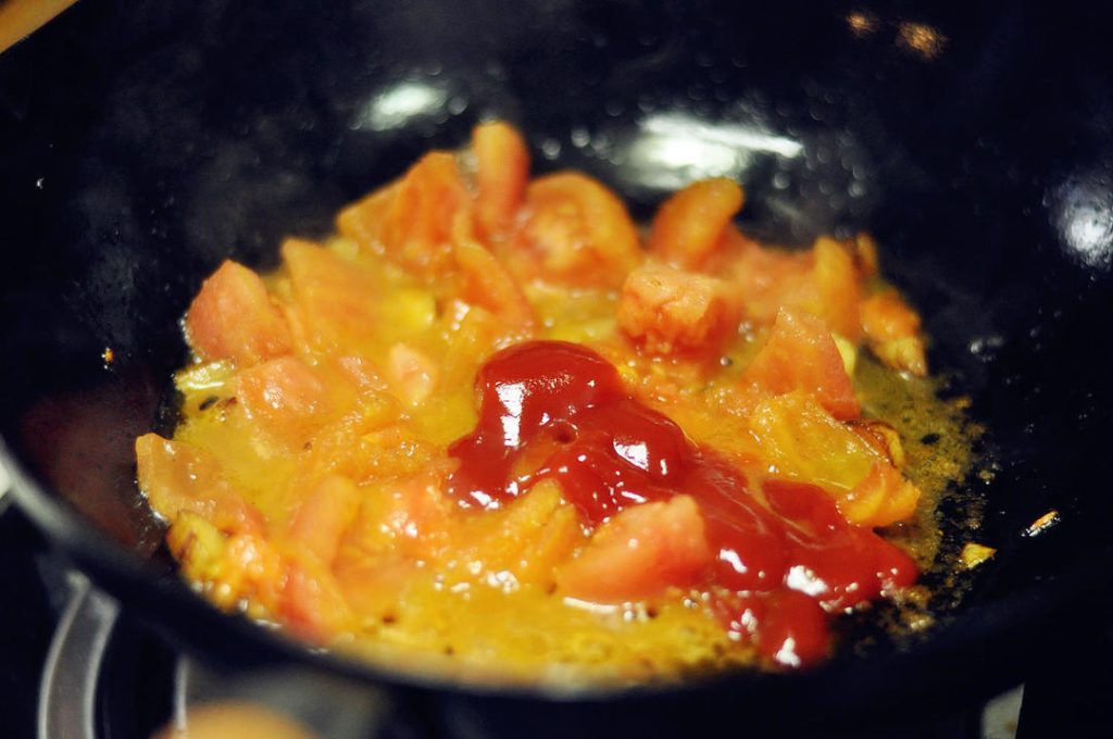 Create the Tomato Base Add the diced tomatoes to the pot. Stir-fry for 2-3 minutes until they break down and release their juices. Add the ketchup (approx. 1-2 tbsp) and stir to combine.