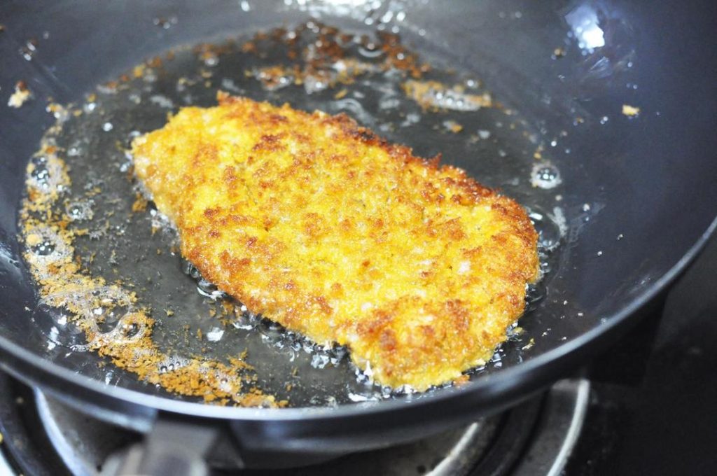 Fry: Carefully lower the pork chop into the oil. Fry over medium heat for about 3-4 minutes, then flip and fry for another 3 minutes. The crust should be a deep golden brown.