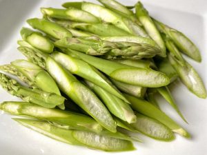 Asparagus Prep: Cut the asparagus on a bias (rolling cut) to expose more surface area. Snap off and discard the woody, tough ends.