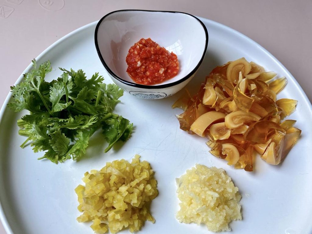 Chop the Toppings: Dice the century eggs and finely chop the Zha Cai. Press or mince your garlic.