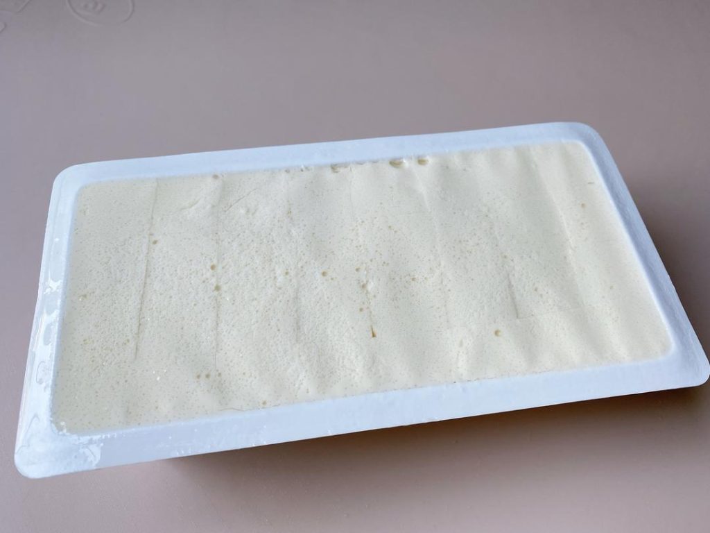 Prep the Tofu: Carefully run a knife around the edges of the tofu box. Invert it onto your serving plate and gently squeeze the sides to release it in one piece. Let it sit for 5 minutes, then carefully pour off the excess water that pools at the bottom of the plate.