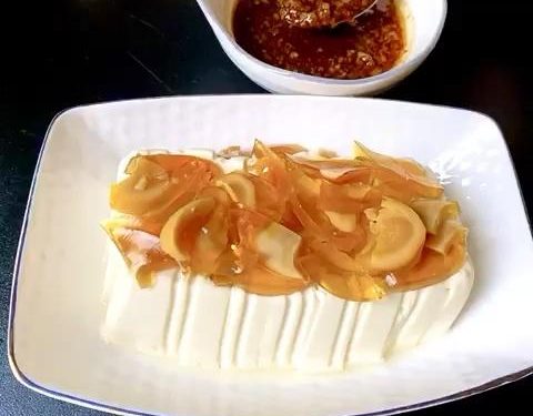 Top the Tofu: Scatter the diced century eggs evenly over the top and sides of the drained silken tofu.