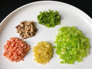 Remove the celery and immediately rinse it under cold running water (or submerge in an ice bath). Once cool, finely dice the celery stalks into 0.2 inch (0.5 cm) pieces. Finely chop the 2 reserved celery leaves.