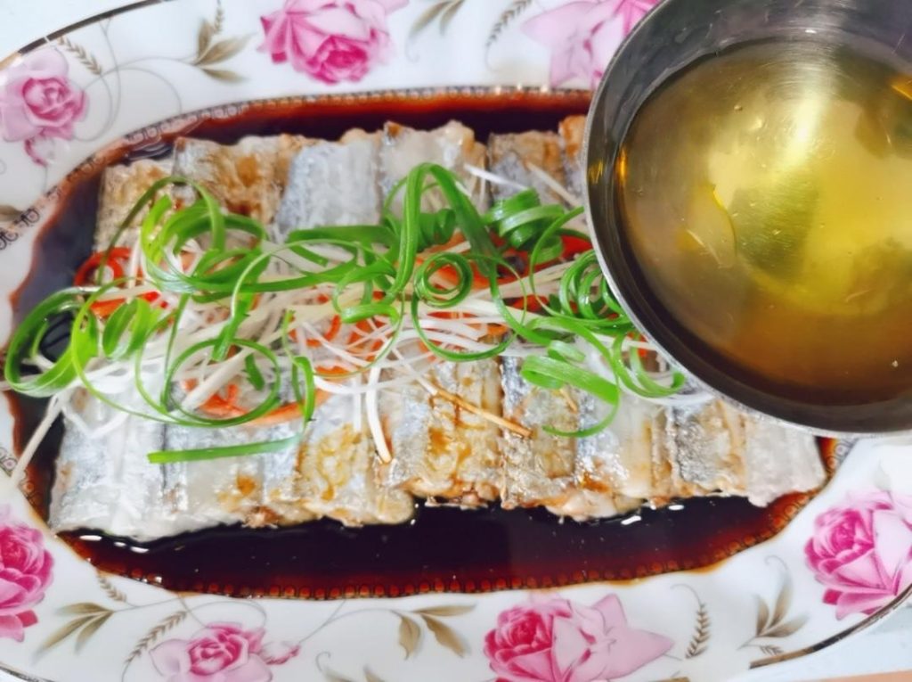 The Sizzle: Pour the warmed soy sauce over the fish.