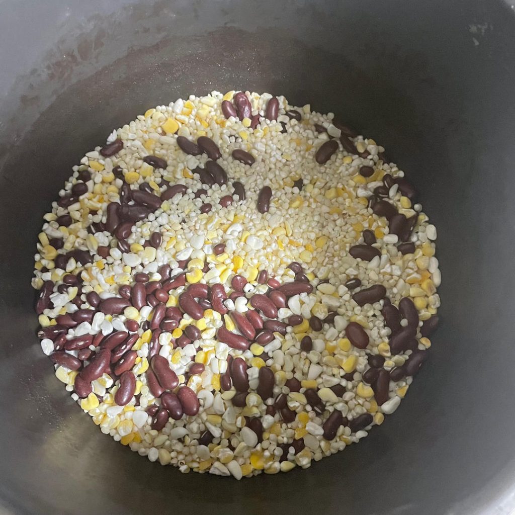Measure and Combine: Place the sorghum, cracked corn, and rice beans into a large mixing bowl.