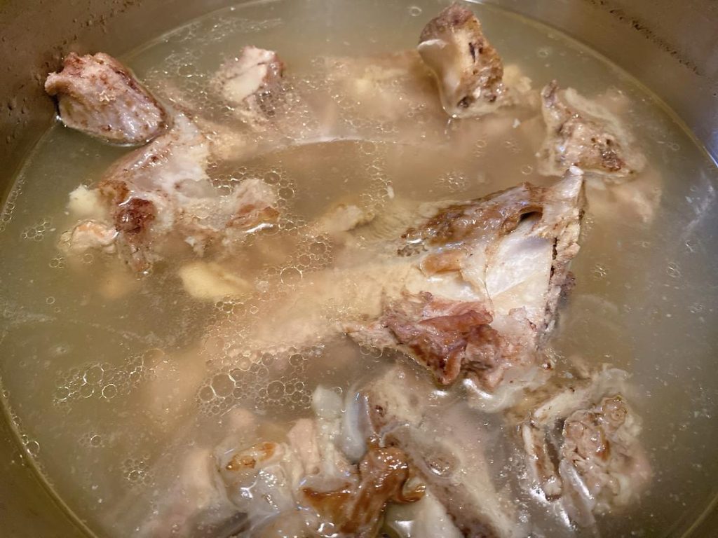Build the Soup: Pour in the pork bone broth and water. Bring to a rolling boil. Season the broth with 1 tablespoon each of Shaoxing wine, soy sauce, oyster sauce, salt, and sugar.