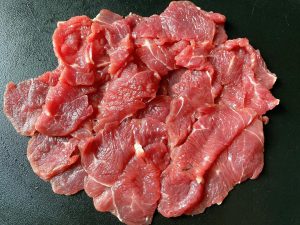 This firms up the meat without freezing it solid, allowing you to cut beautiful, even "butterfly" slices against the grain.