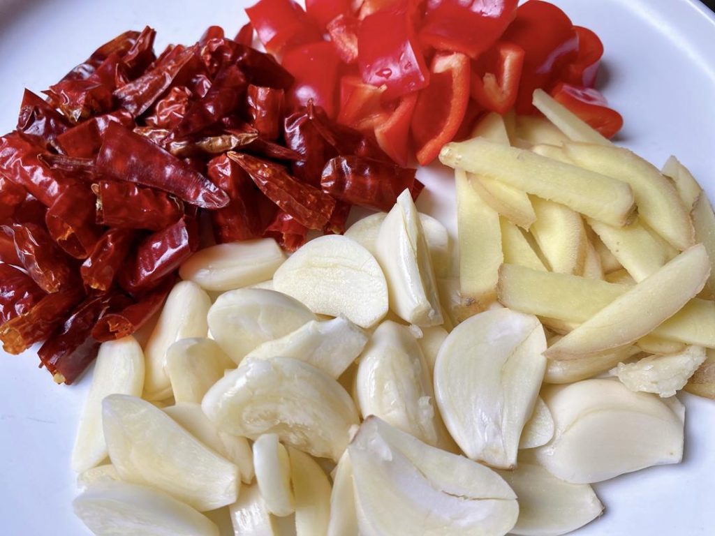 Chop the Veggies: Slice your garlic and ginger, cut the scallions into sections, and chop the red bell pepper. Keep them in separate small bowls near your stove.