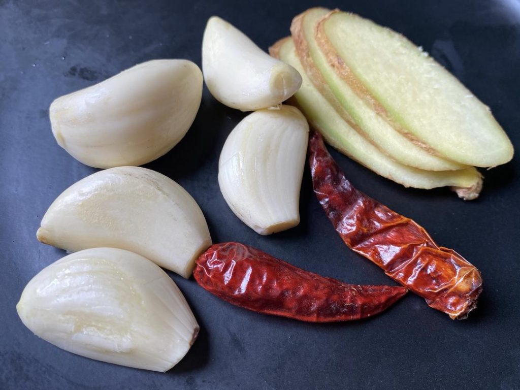 Prepare the Aromatics: Mince your ginger, garlic, and chilies so they are ready to hit the hot oil.
