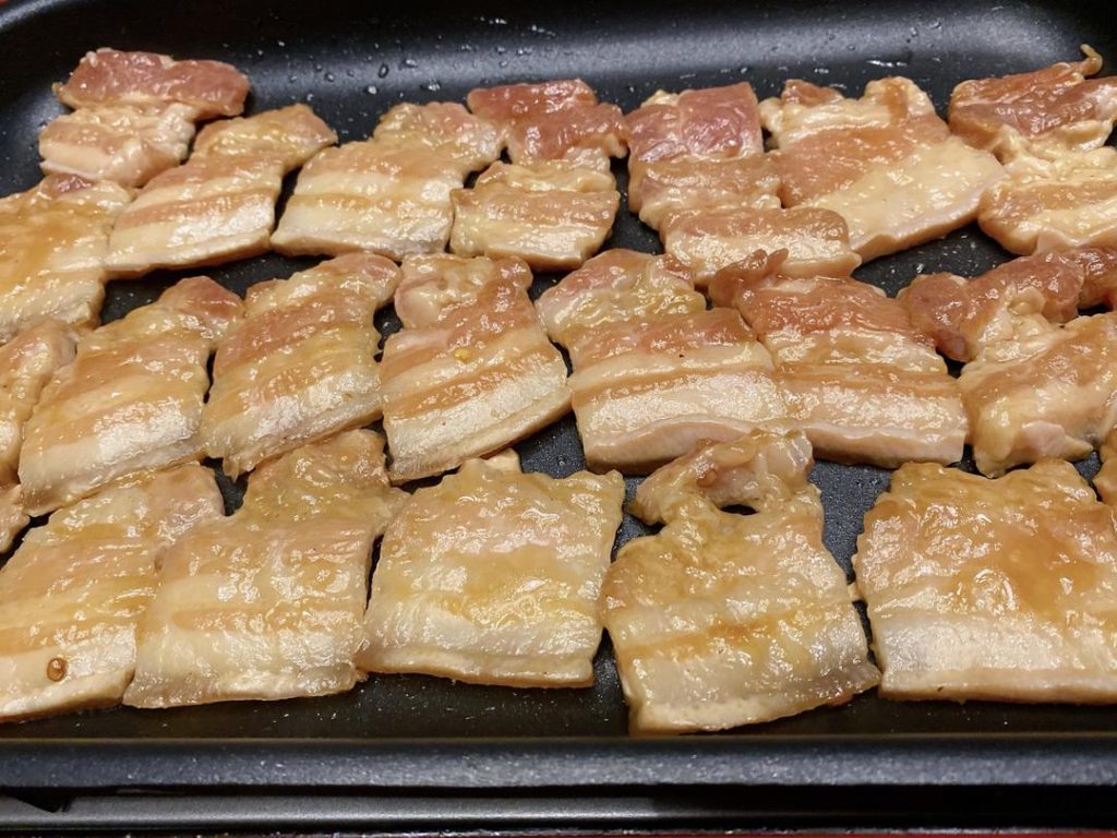 Grill the Pork: Heat your griddle or skillet over medium-high heat. Lay the marinated pork slices flat on the surface. You will immediately hear the satisfying sizzle. Cook for about 2–3 minutes per side until golden brown and slightly caramelized.