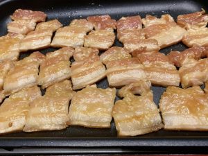 Grill the Pork: Heat your griddle or skillet over medium-high heat. Lay the marinated pork slices flat on the surface. You will immediately hear the satisfying sizzle. Cook for about 2–3 minutes per side until golden brown and slightly caramelized.