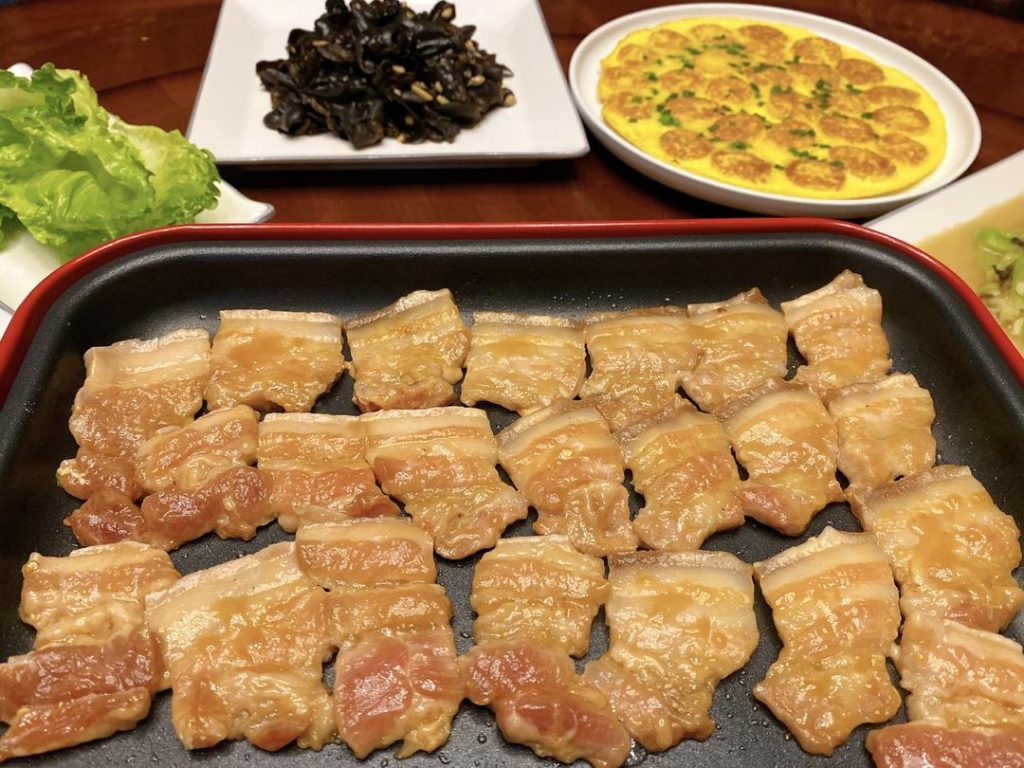 Grill the Pork: Heat your griddle or skillet over medium-high heat. Lay the marinated pork slices flat on the surface. You will immediately hear the satisfying sizzle. Cook for about 2–3 minutes per side until golden brown and slightly caramelized.