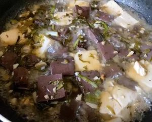 For Method 1: Heat 1 tbsp of oil in your wok over medium heat. Sauté the garlic and the white parts of the scallions (or chive stems) until fragrant. Toss in the pickled mustard greens and stir-fry for 30 seconds.