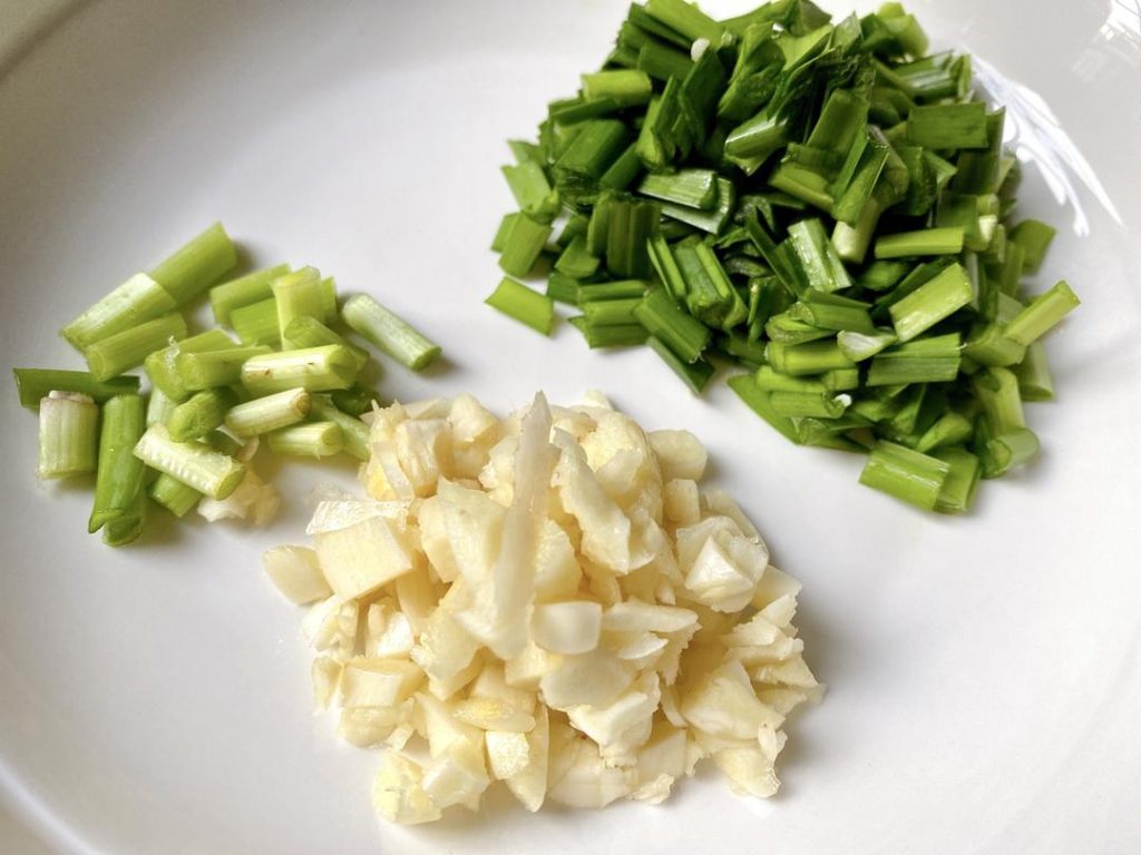 Chop Aromatics: Mince your garlic, slice your ginger, and cut your scallions or chives into 1-inch pieces.