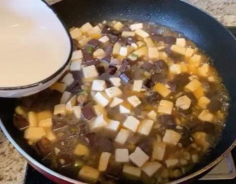 For Method 2: Give your cornstarch slurry a quick stir, then drizzle it into the simmering liquid in stages. Gently swirl the wok until the sauce thickens and clings to the tofu and blood curd (you might not need all the slurry). Fold in the scallion greens or chives, and serve immediately.