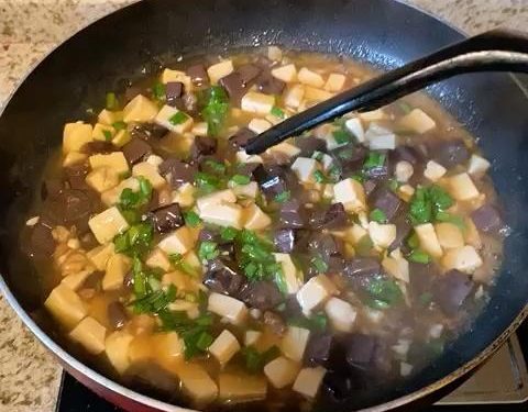 For Method 2: Give your cornstarch slurry a quick stir, then drizzle it into the simmering liquid in stages. Gently swirl the wok until the sauce thickens and clings to the tofu and blood curd (you might not need all the slurry). Fold in the scallion greens or chives, and serve immediately.