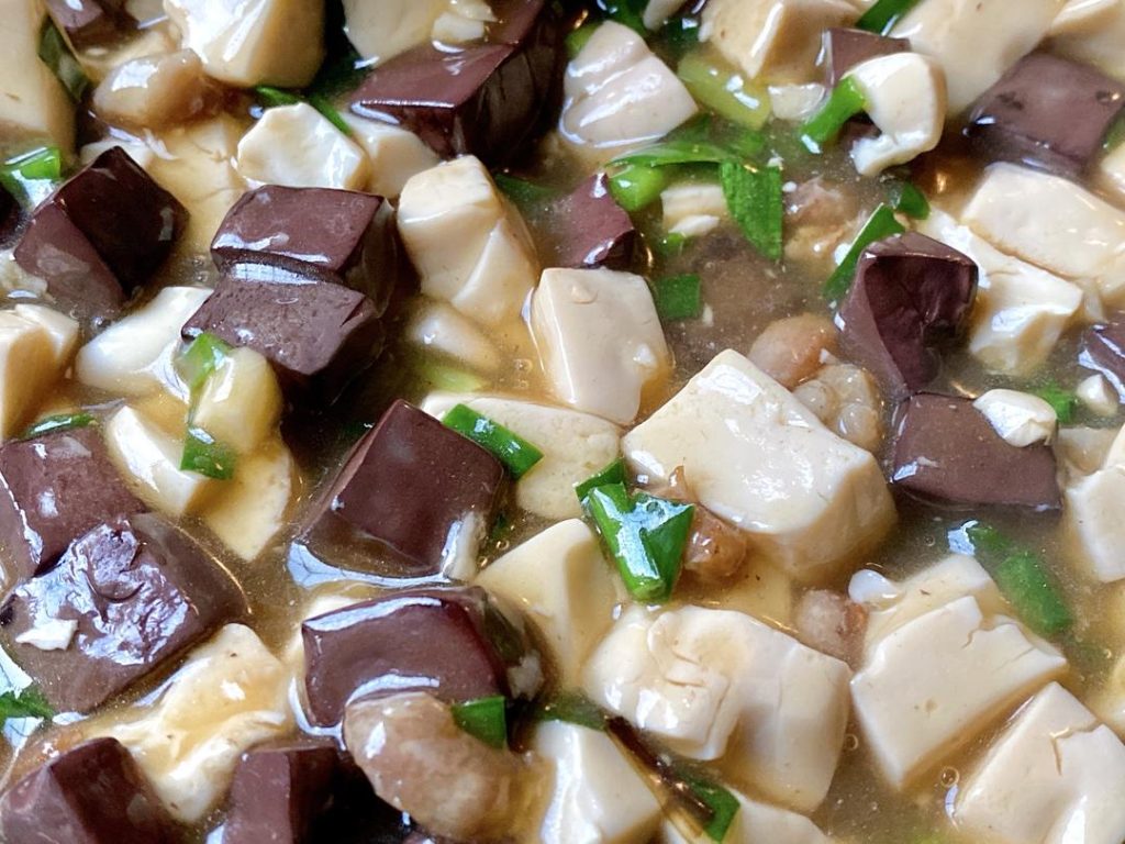 For Method 2: Give your cornstarch slurry a quick stir, then drizzle it into the simmering liquid in stages. Gently swirl the wok until the sauce thickens and clings to the tofu and blood curd (you might not need all the slurry). Fold in the scallion greens or chives, and serve immediately.