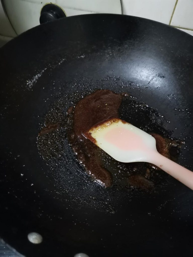 By melting the sugar in the dry pot, we are initiating caramelization (pyrolysis). The sugar breaks down into hundreds of new, complex flavor compounds that provide the signature dark color and slightly bitter, roasted depth characteristic of aged Light Soy Sauce.
