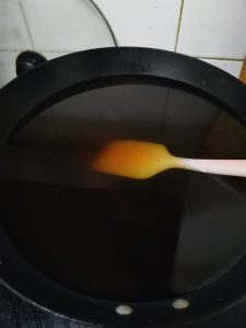 Add the water: Once the sugar has melted and turned a deep amber color, very carefully pour in the 2500ml of warm water.