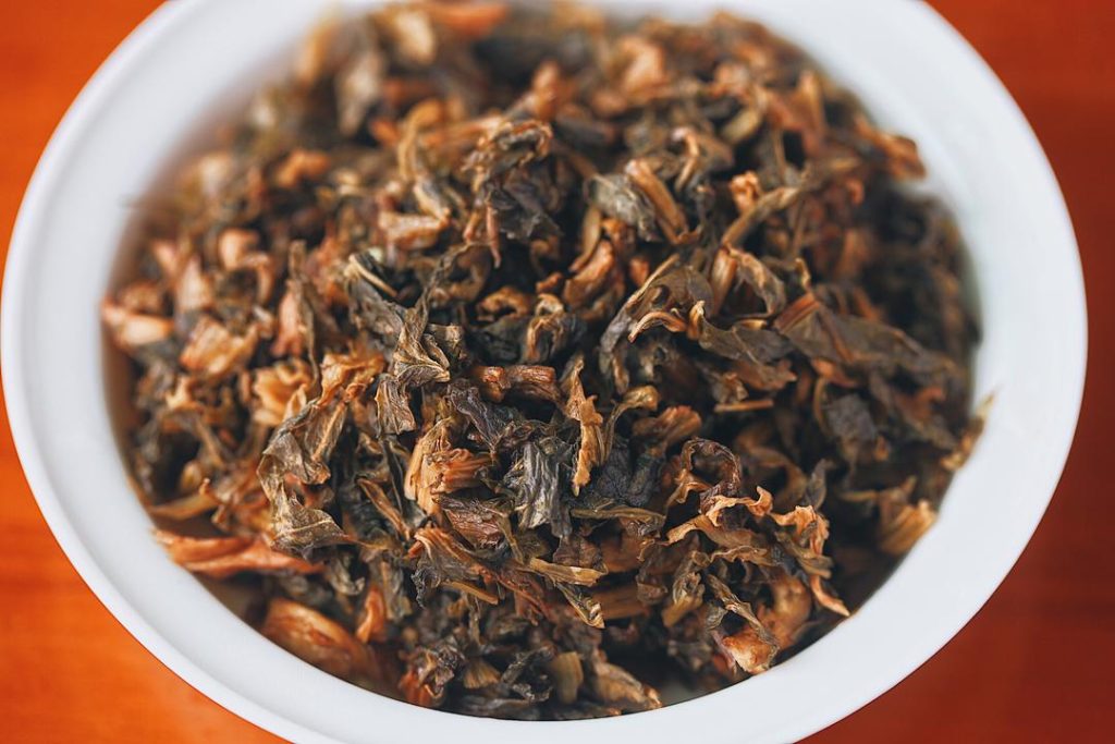 Mei Gan Cai often contains sand or grit. Soak it until soft, then rinse it vigorously through several changes of water. Squeeze it completely dry and chop it into fine pieces.