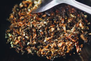 Add the chopped Mei Gan Cai and stir-fry over medium-low heat for about 2 minutes. The greens are very absorbent, but don't overdo the oil; the ribs will release more fat during the steaming process.