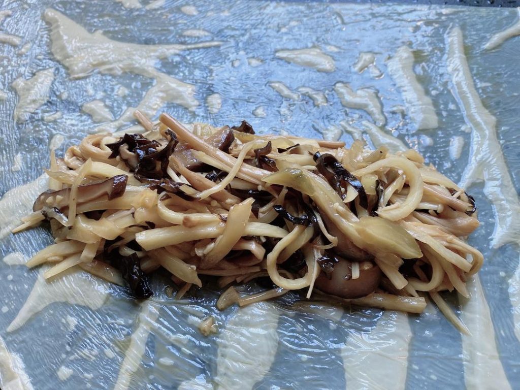 Wrap the Rolls: Cut the 2 large tofu skin sheets in half to create 4 semi-circles.