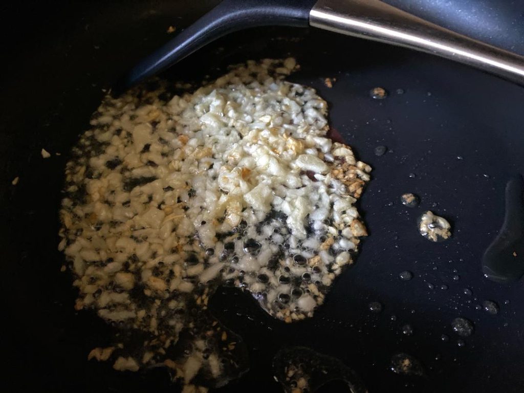 Sauté the Filling: Heat 1 tablespoon of oil in a wok over medium-high heat. Add the minced garlic and sauté until fragrant (about 30 seconds). Add the drained vegetables and stir-fry.