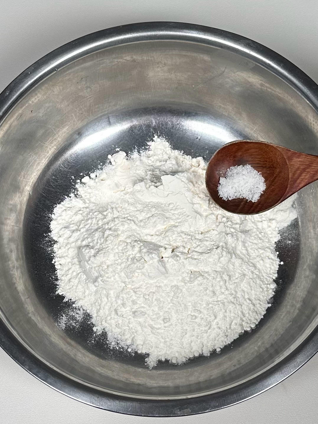 Mixing flour water and salt into dough flakes