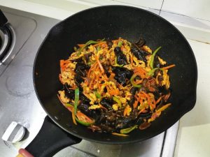 Stir-frying until the sauce thickens and coats everything