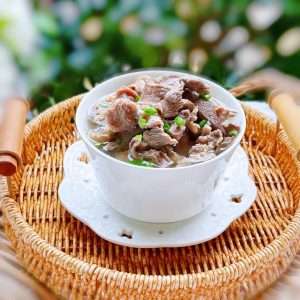 A bowl of ba dao tang, the Hakka eight-cut pork offal soup with sliced offal in a clear savory broth