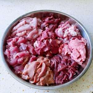 Wash and thinly slice all eight cuts of pork offal: shoulder, heart, liver, kidney, intestine, lung, tongue and membrane.