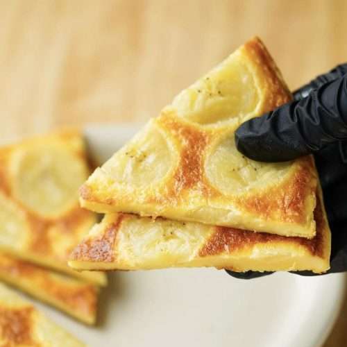 A thick golden banana egg pancake, soft and cake-like, ready to slice