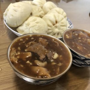 Season the simmering intestines with sweet bean paste, soy, sugar, and aromatics