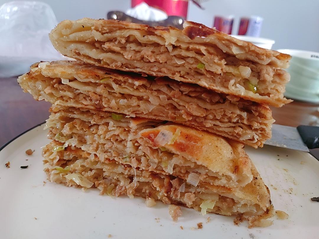 Golden pan-fried zhuang mo bread stacked in tall wedges