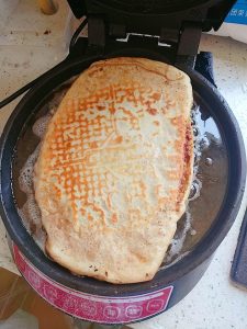 Roll the filled dough up into a layered towel-shaped tower