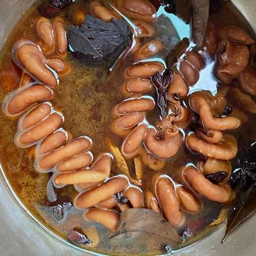 Glossy braised pork intestines in a dark spiced soy braising liquid