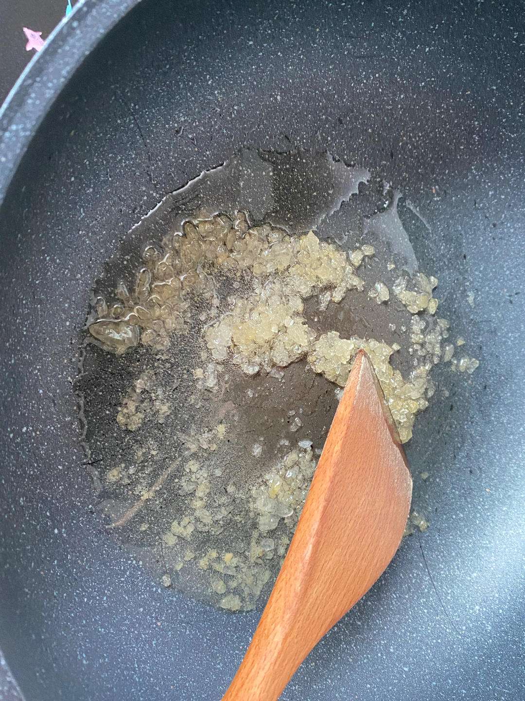Melt the rock sugar over low heat into amber caramel for the color