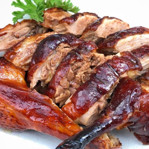 Whole roasted Cantonese duck with glossy mahogany skin