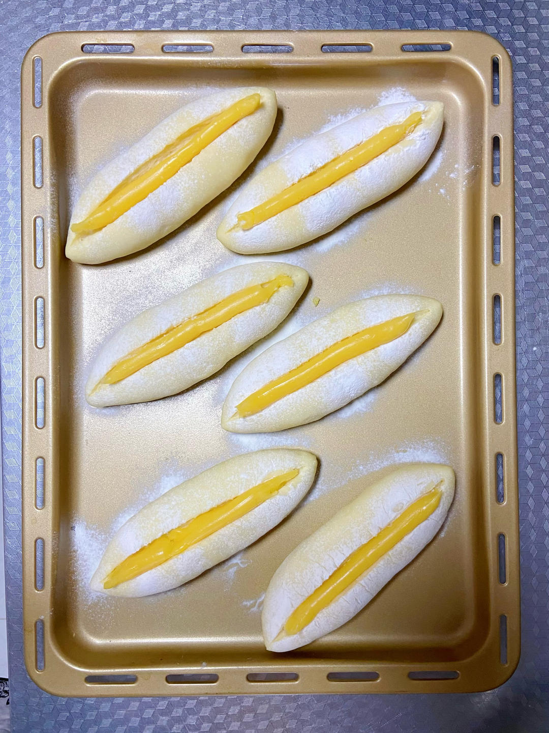 Pipe the cheese sauce into the slash and across the top of each bun - the amount finishes exactly 12 buns.