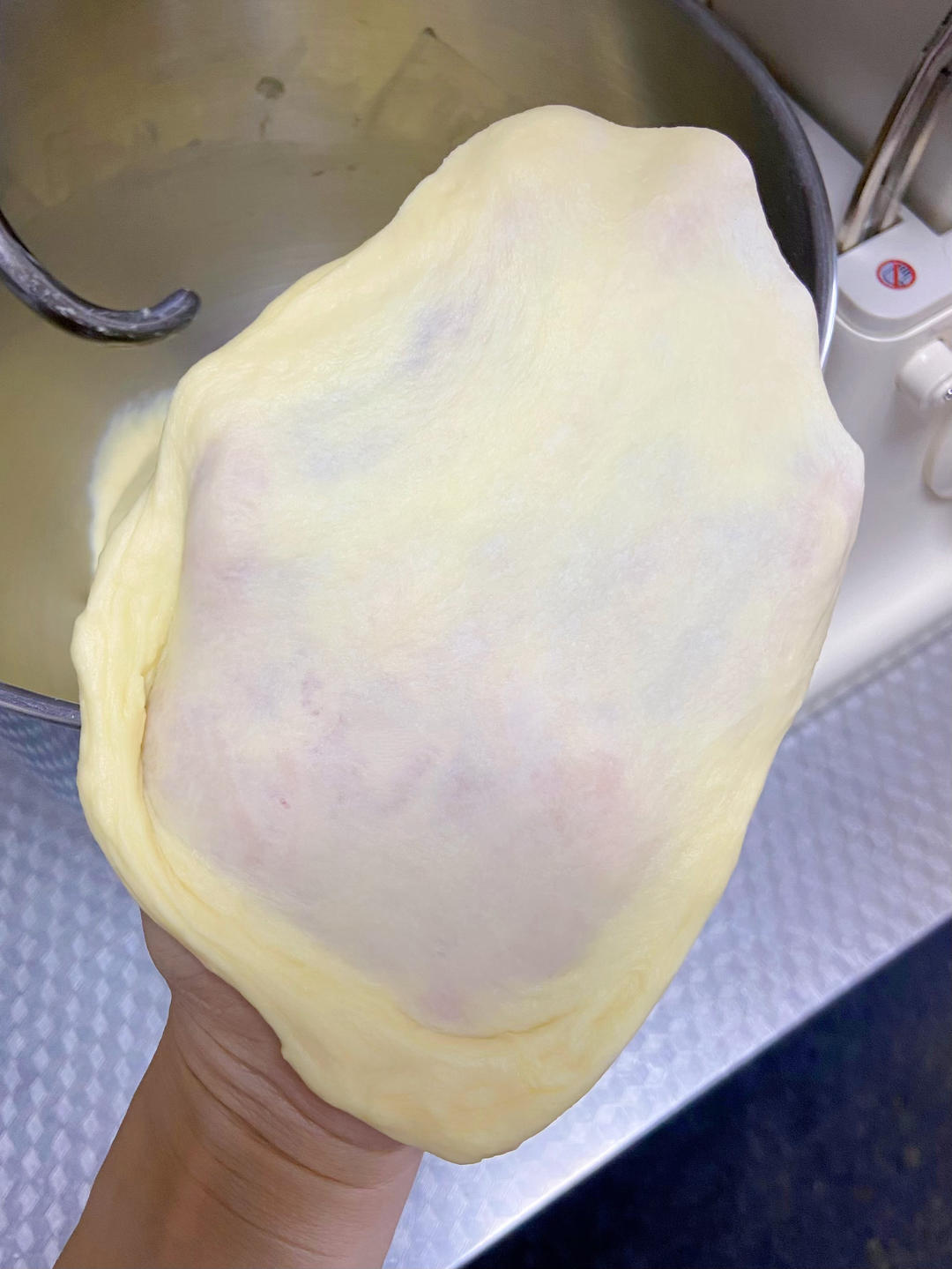 The dough is ready when a small piece stretches into a thin, translucent membrane without tearing - the windowpane test.