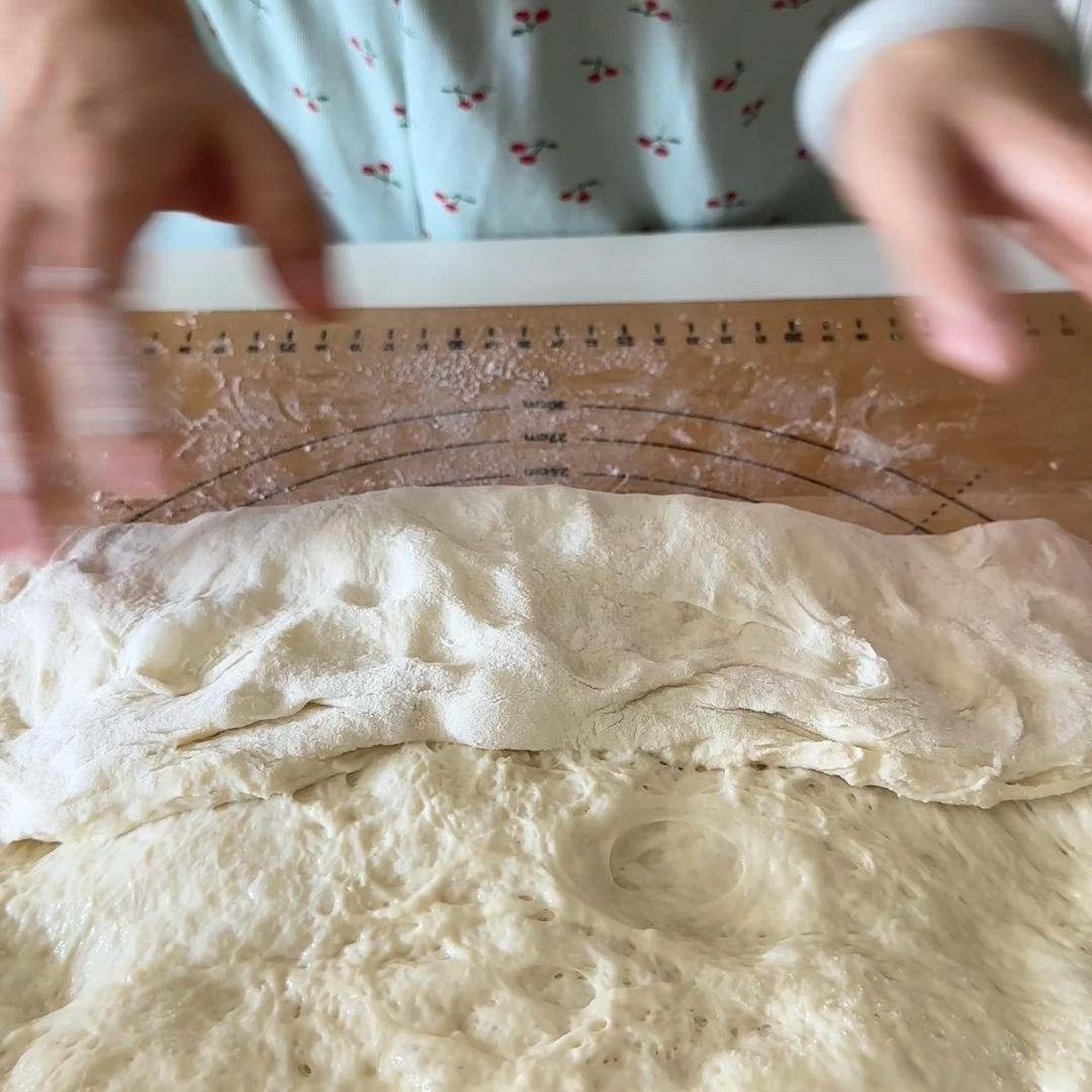 Fold the bottom edge of the rectangle up over the middle, like folding a blanket.