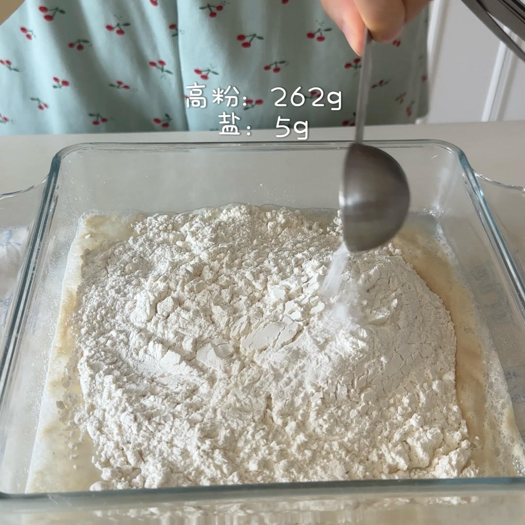 Combine the remaining room-temperature water with the dry ingredients and the activated yeast, mixing with a spatula.