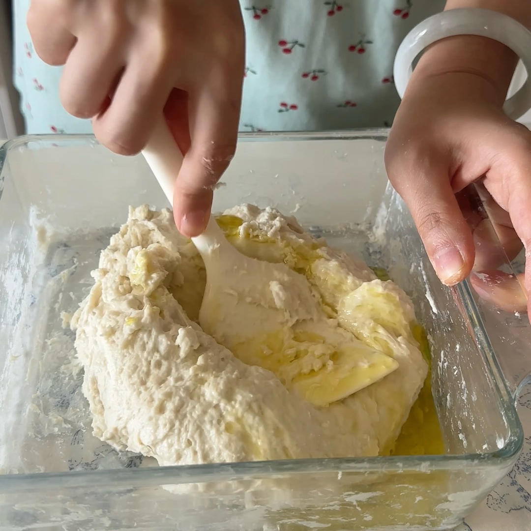 Keep folding until the olive oil is fully absorbed and the dough becomes a sticky, elastic mass.