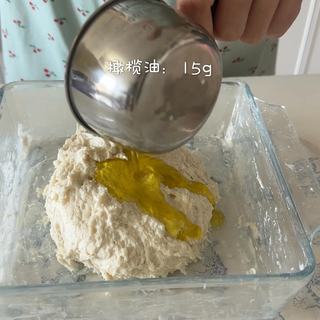 Mix until no dry flour remains, then pour in the olive oil - the dough will be shaggy and very wet.