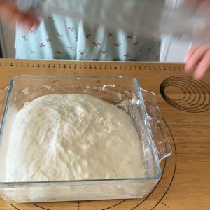 Dust the work surface generously and turn the fermented dough out onto it without deflating.