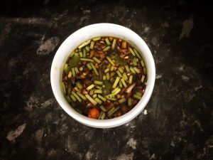 Pound the garlic and mix the chili-lime-fish-sauce dressing